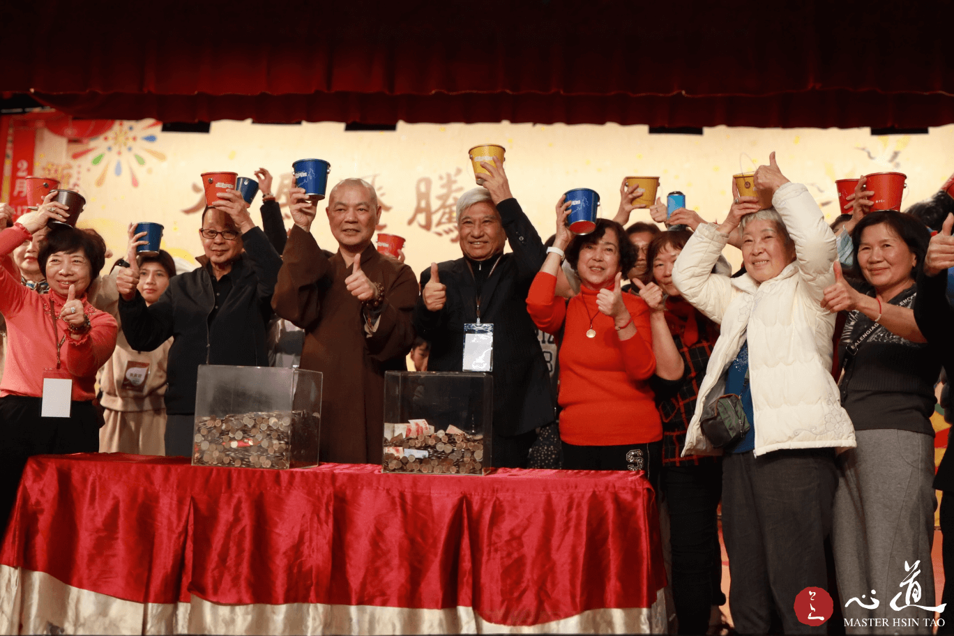 灵鹫山心道法师与荣董贵宾于新春祈福活动，手持福桶合影并响应募款